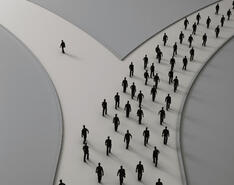 At a forked path, one person takes the path to the left while everyone else chooses the path to the right.