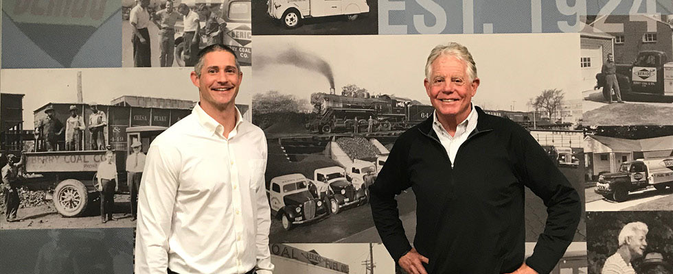 Owners of the Berico pose in front of a sign.