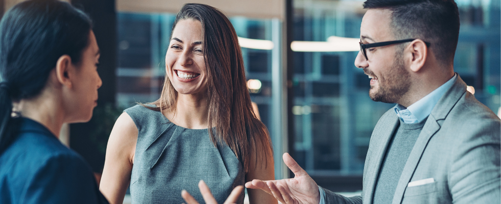 An image shows coworkers laughing together.