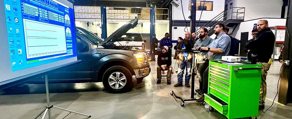 Employees reading analytics on a truck