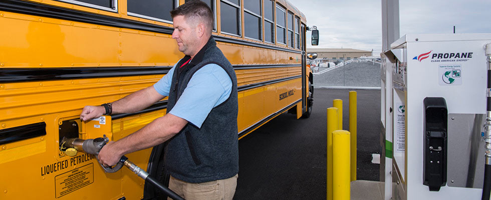 A man filling up a bus with autogas