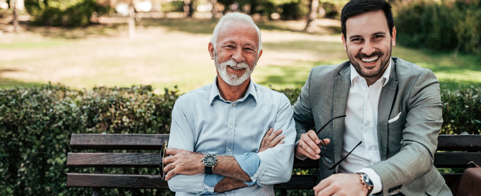 An older man poses with a young man, presumably father and son, showcasing bringing family into your propane business.