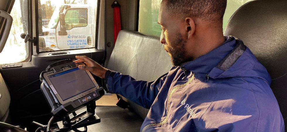 A Paraco Gas employee uses the company's digital customer relationship management software installed in the cab of a truck.