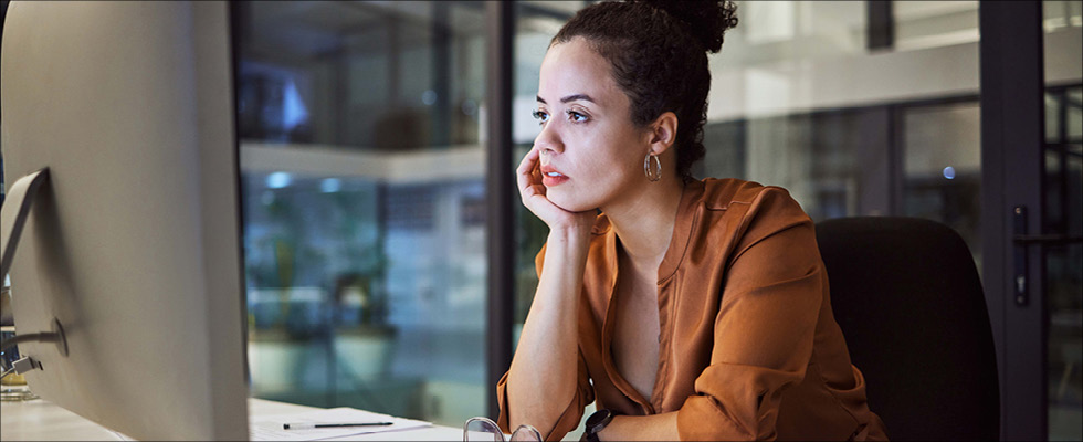 A woman sits at her computer, searching online for a tax professional