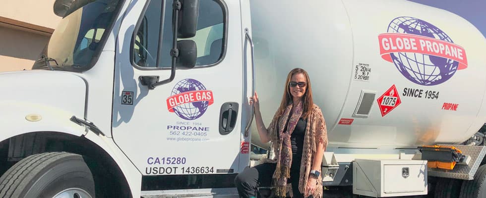 Karen Dixon near a Globe Propane Truck