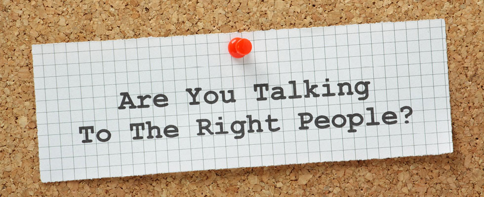 A note pinned to a board saying, "Are You Talking To The Right People?"