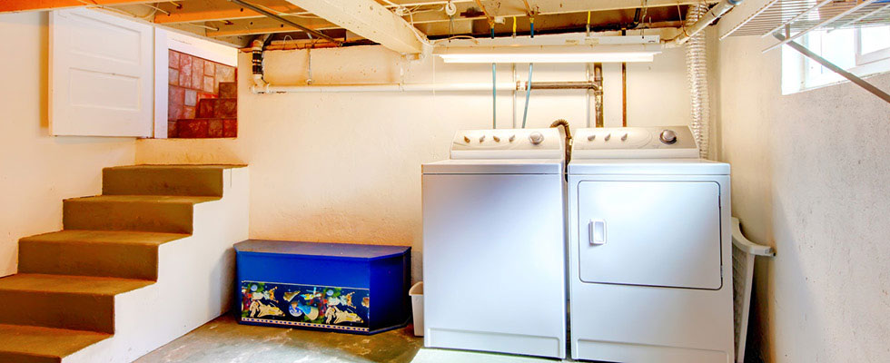 A downstairs space includes a washer and dryer.