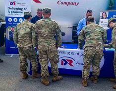 Dead River Company employees participate in a veteran recruitment event in front of a company truck